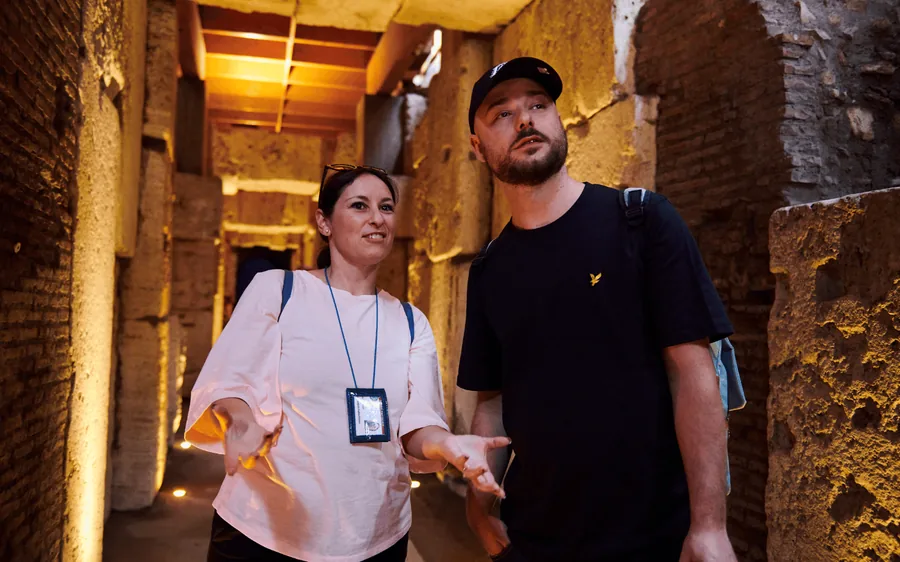 A private guide with two visitors inside the Colosseum